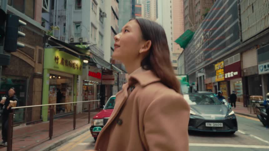 Girl crossing the street of an eastern city and smiling