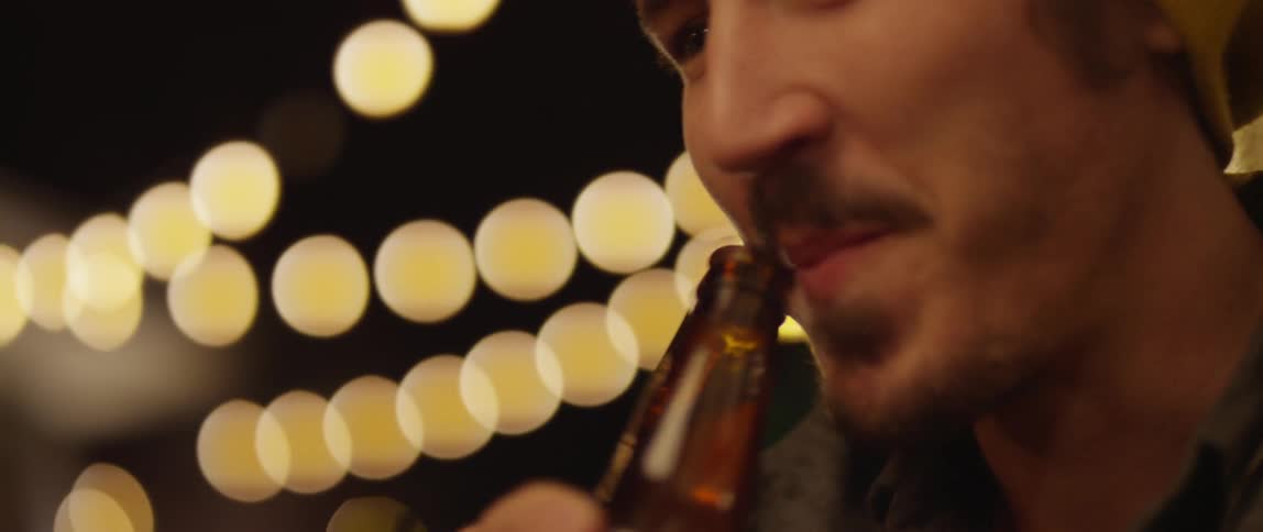 Man smiling and drinking beer
