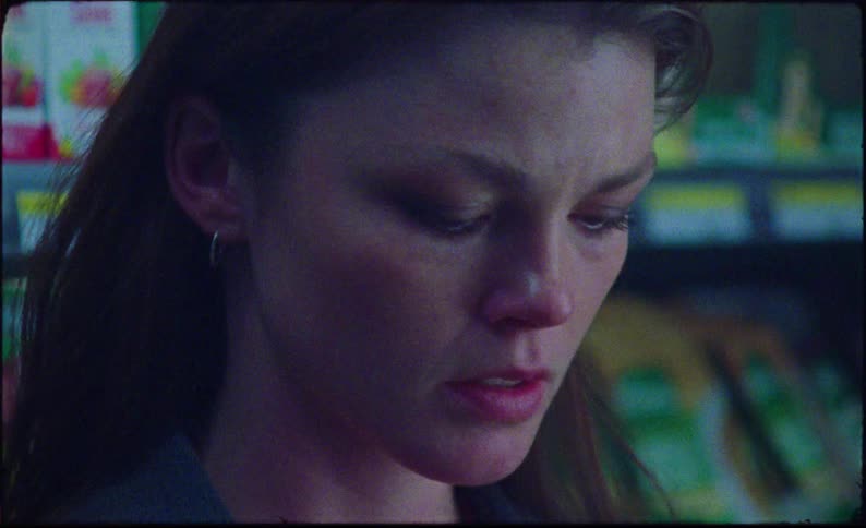 Worried looking woman inside a supermarket