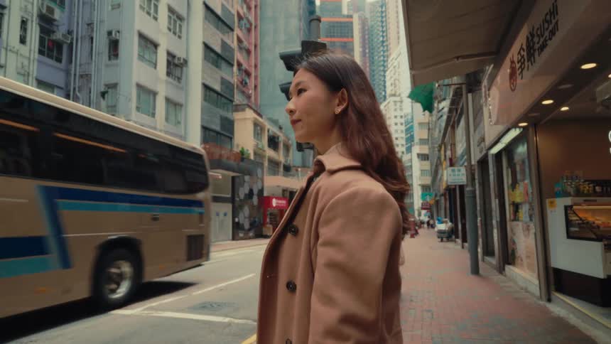 Girl waiting on the sidewalk of a busy eastern city