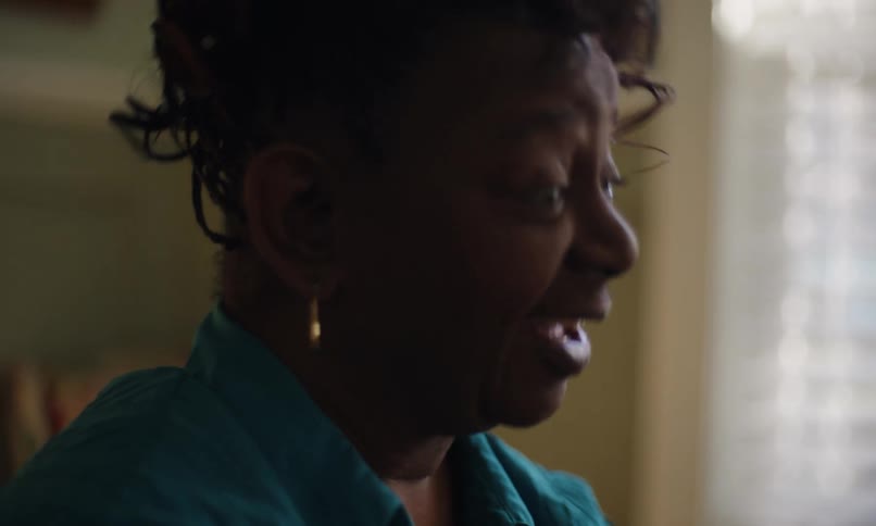 A woman is talking and smiling