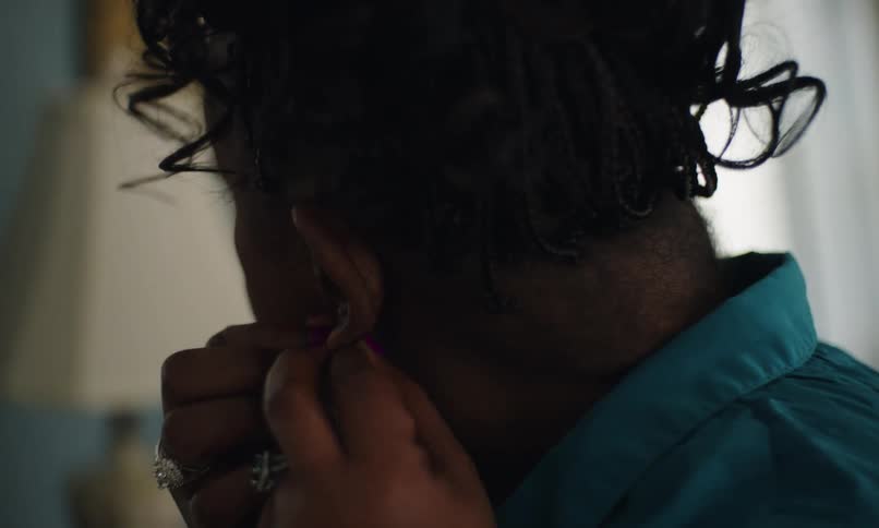 A woman puts on her earrings