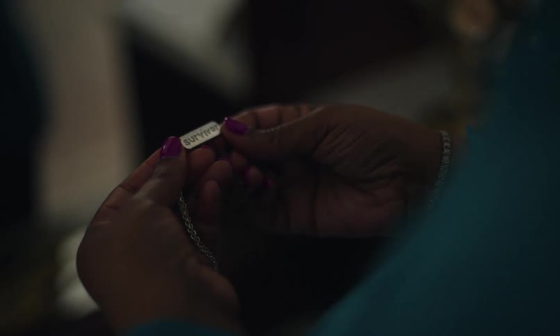 A footage of a person holding a metal tag