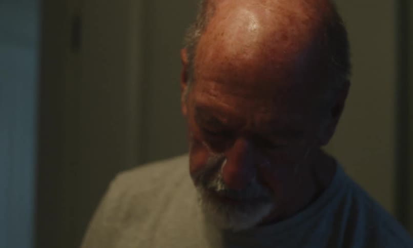 Man shaving himself in the mirror