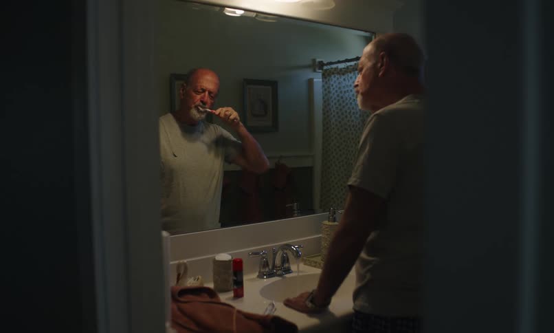 A man is brushing his teeth
