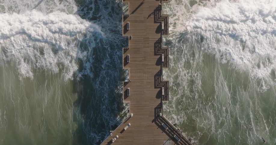 Aerial view of a long pier on the beach