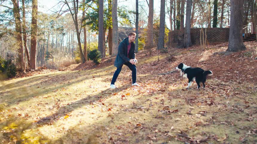 A man plays with his dog