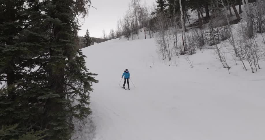 Two people skiing on a snowy mountain