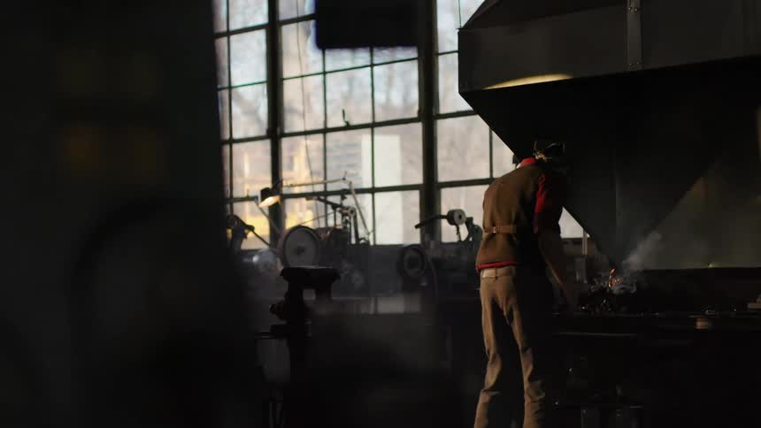 A footage of a person working at a forge