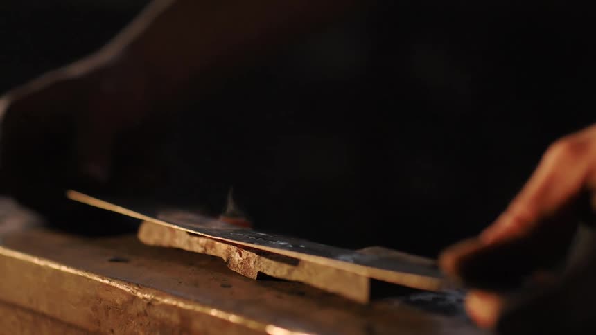 Blade being worked with a hammer in a workshop