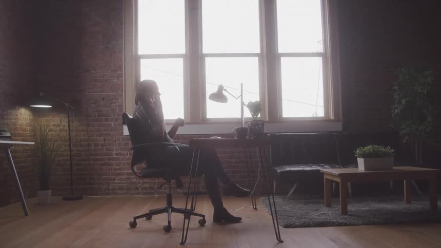 A footage of a person sitting in the room