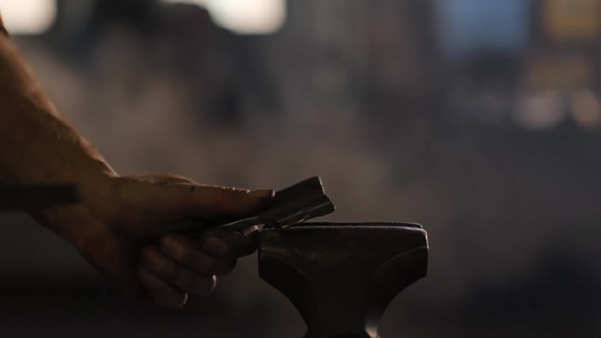 Mans hands working iron