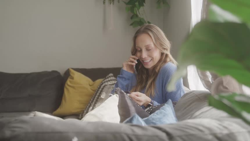 A footage of a lady having a phone conversation indoor