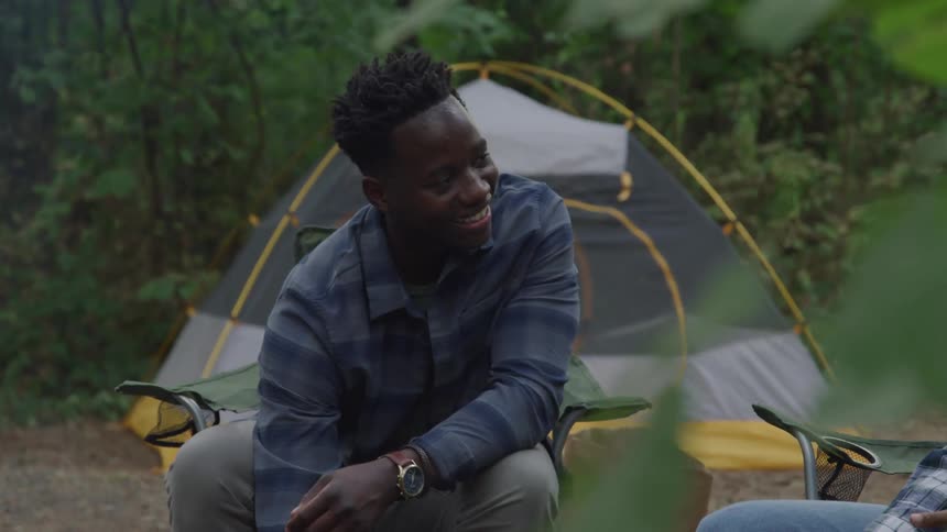 A footage of a black teenage boy at a camp site