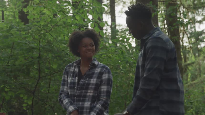 2 boys cooking together in the middle of the woods