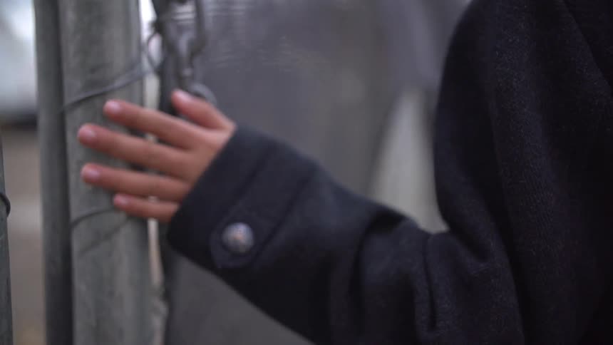 Hand rubs along a chain link fence