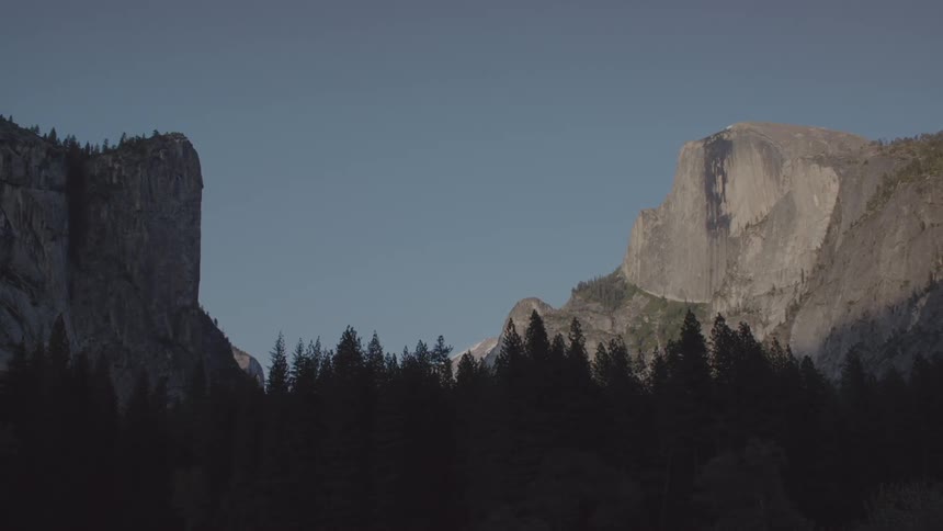 Large mountain behind a forest