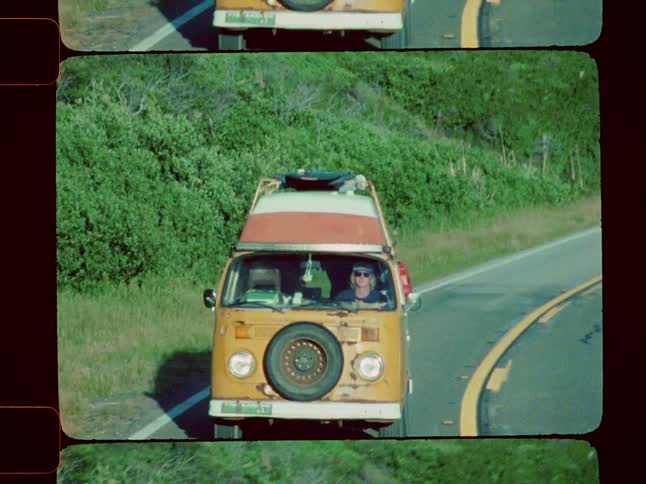 Boy driving a van through the roads of a mountainous landscape