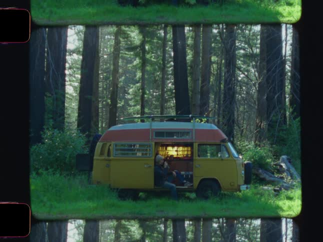 A man is sitting in his van in the forest