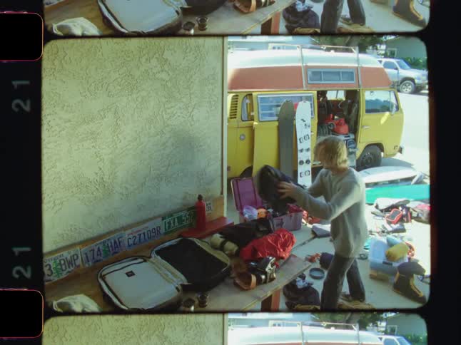 A man is packing up clothes to put in his van