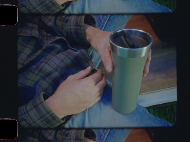 Seated man holding a cupglass
