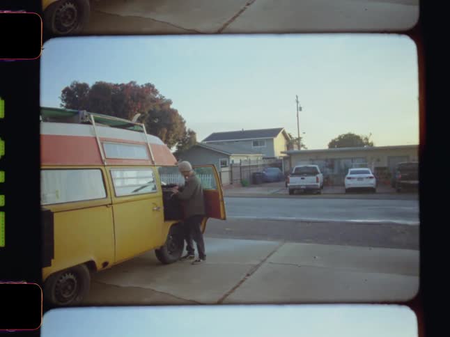 Man taking things inside a stationary van