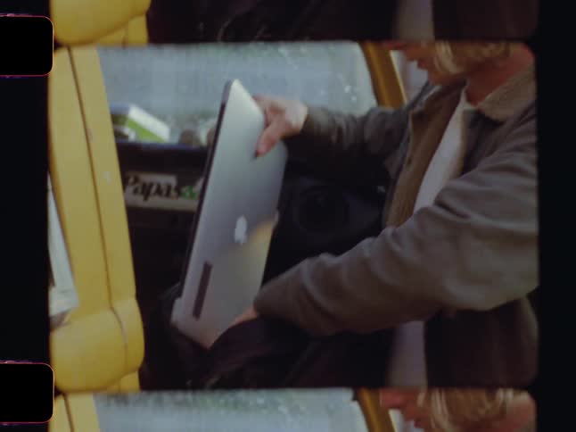 A man packs up his laptop