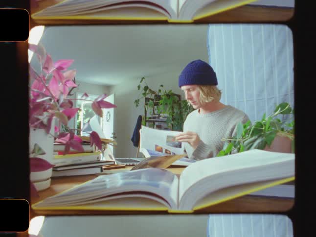 Boy inside a room reading a book