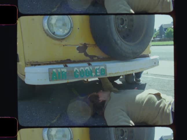 A footage of a person working under a van