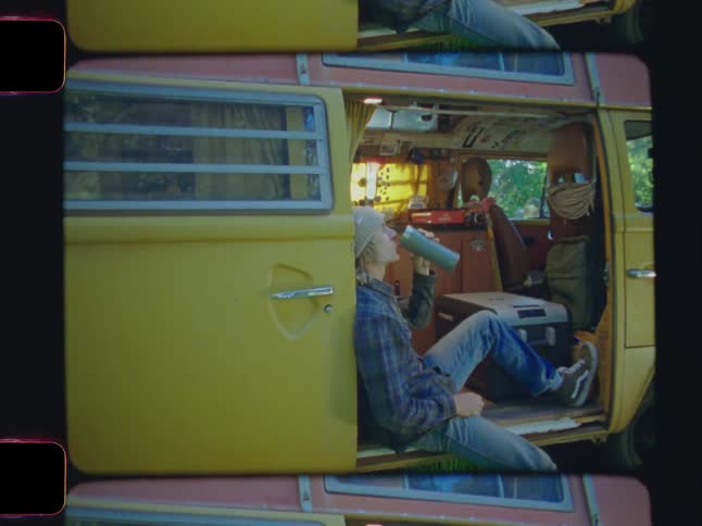 Man sitting in an rv drinking from a cup