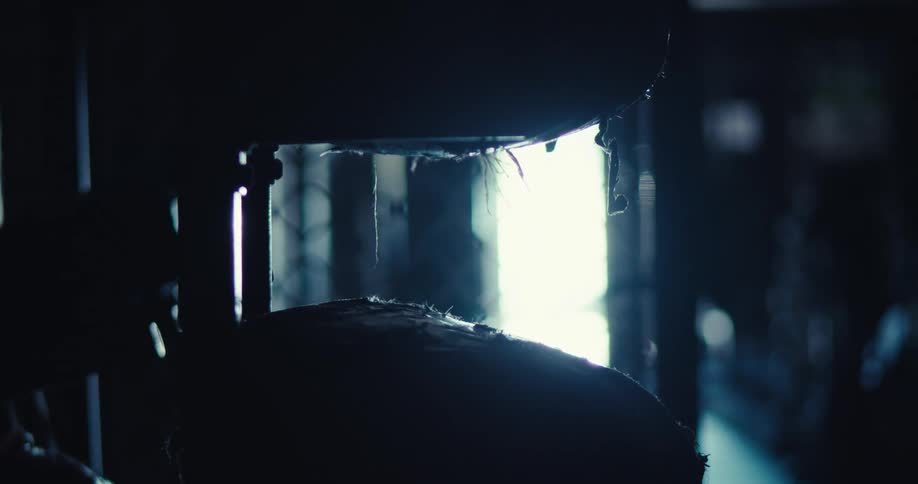 Light shines in the doorway into the dark room