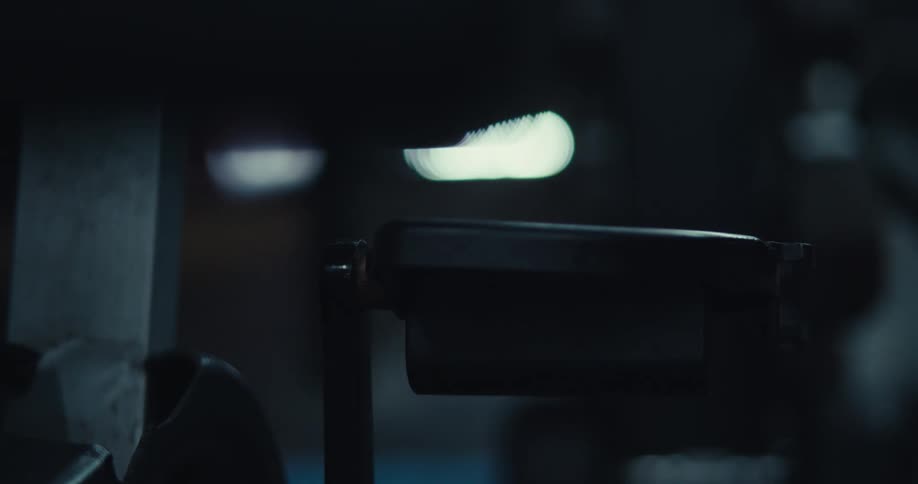 A person uses their hand to move the pedal on an exercise bike