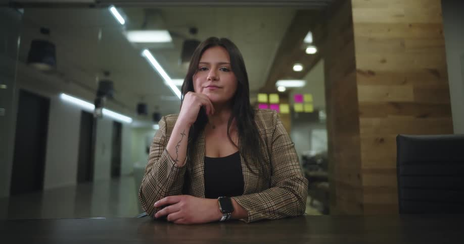 The office worker has her hand to her chin