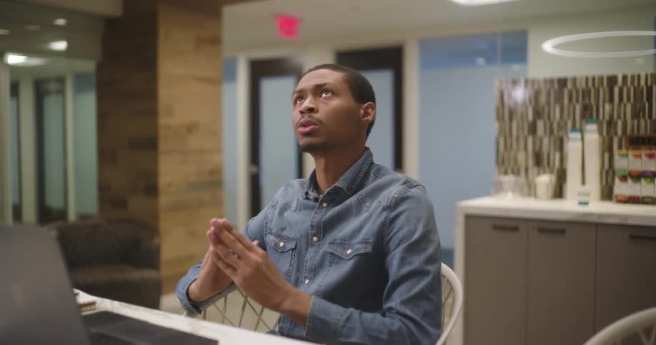 Guy sitting at a desk talking on a computer call