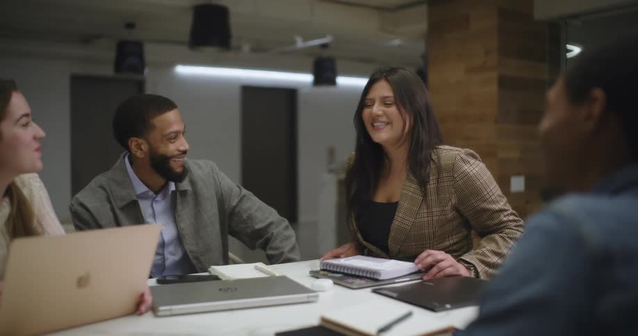 People talk and laugh during a meeting