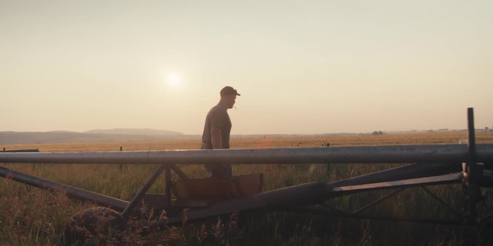 Man working with a tool in the fields