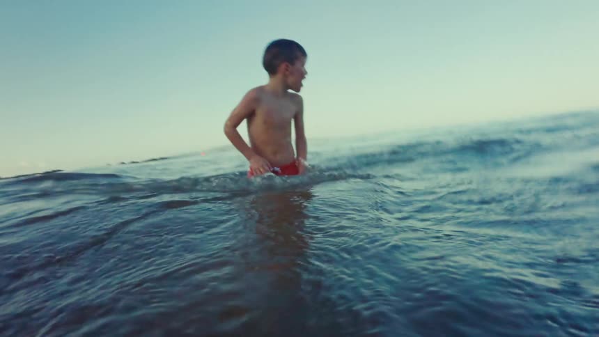 Child swimming happily in the sea
