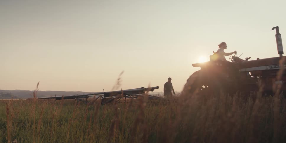A farmer drives a tractor through a field