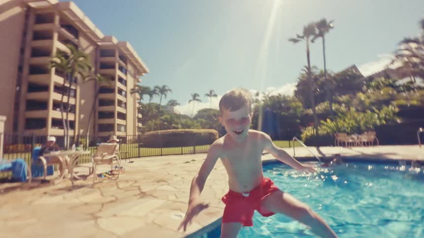 Child diving into the pool happy