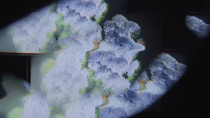 A closeup of a screen reveals pixelated abstract shapes and patterns