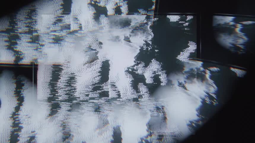 Close up of a screen showing distorted static images with flickering effects