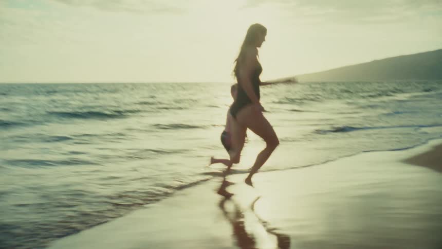 A footage of a mother playing with her son at the beach