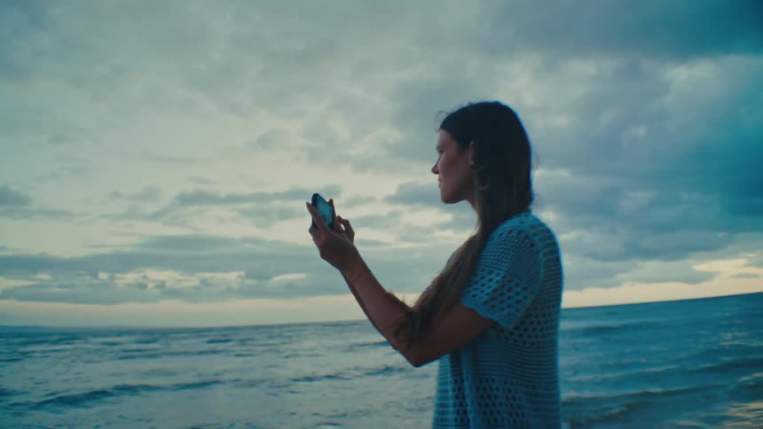 Girl smiling while taking a photo at the beach