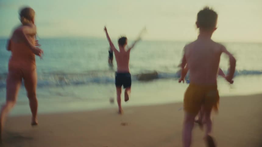 Children running happily to the sea