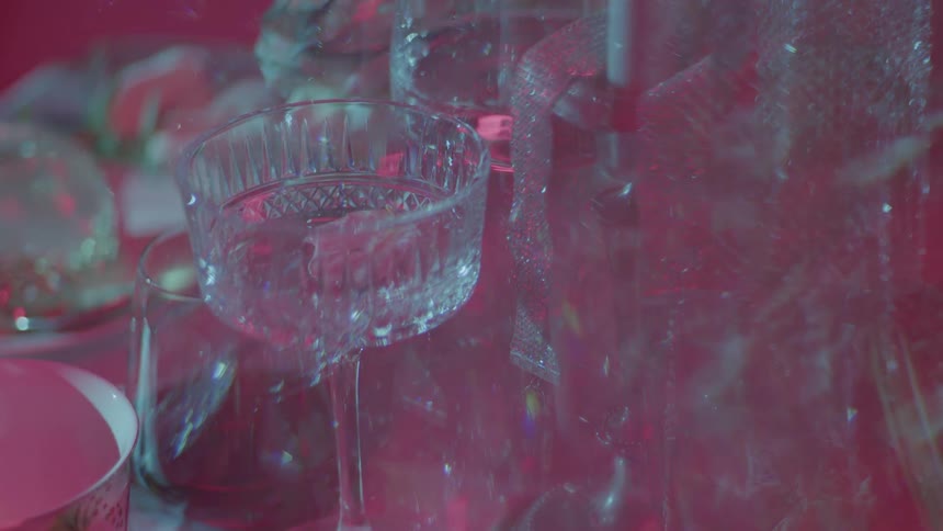 Smoke and lights help create a pattern with stemware