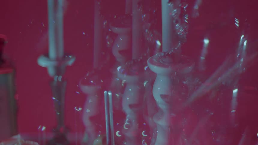 Candle sticks contrast with a red background