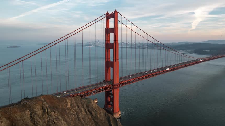 Traffic moves on the long red bridge