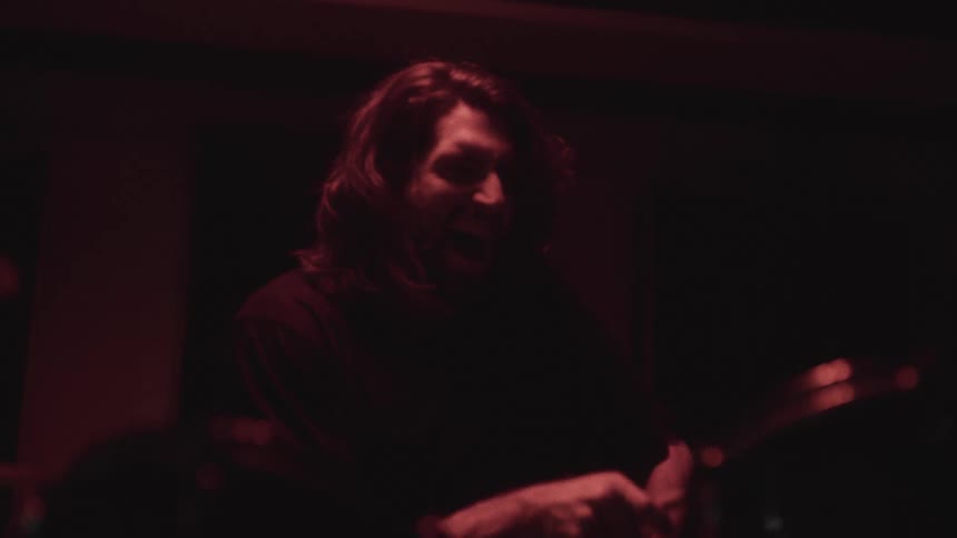 The musician is having fun while playing the drums