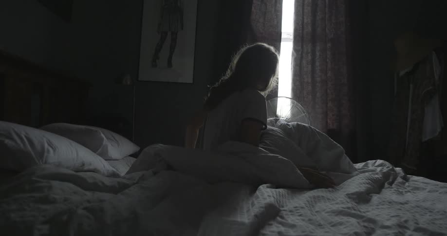 A person getting out of bed
