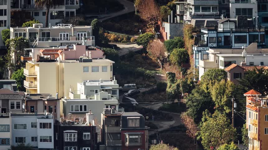 Cars drive down the winding road downhill